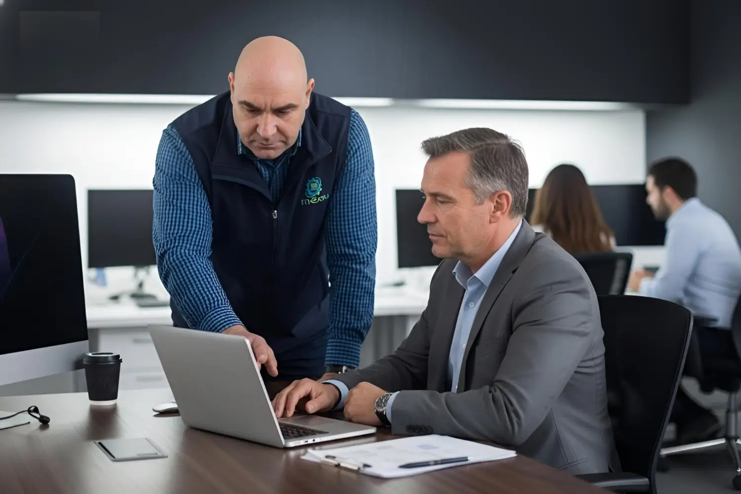 onsite IT Business Consultant helping an businessman with his computer problems